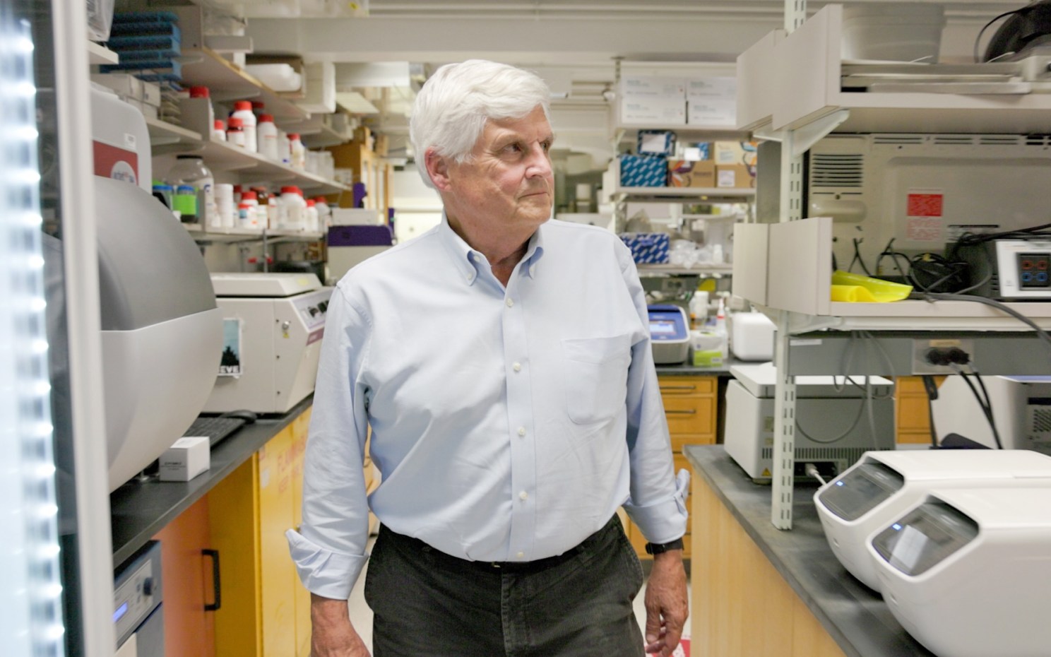Researcher David Corey walks through his lab.
